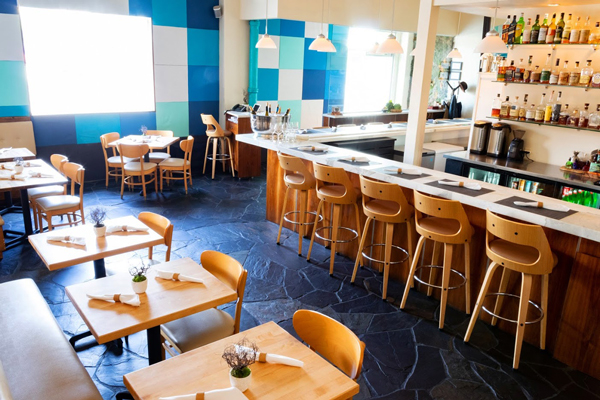 Blue interior with wooden chairs and tables